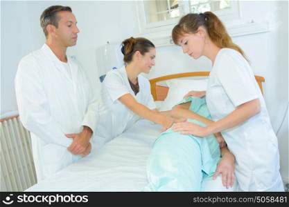 Patient being rolled on hospital bed