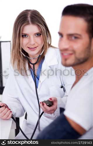 Patient checking his blood pressure in the hospital by the female doctor