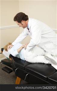 Patient getting a spinal adjustment from her chiropractor.