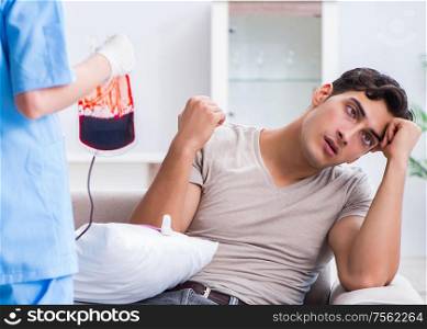 Patient getting blood transfusion in hospital clinic. The patient getting blood transfusion in hospital clinic