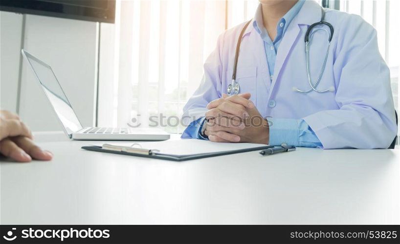 patient listening intently to a male doctor explaining patient symptoms or asking a question as they discuss work together in a consultation
