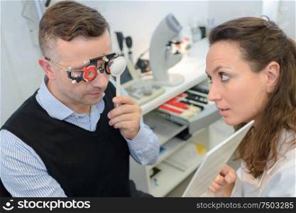 patient on optometrist eye test with eye chart