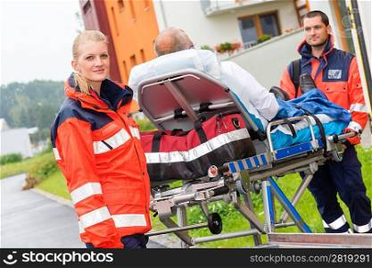 Patient on stretcher with paramedics ambulance aid emergency woman man