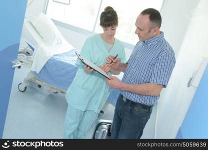 patient signing medical health record paper form