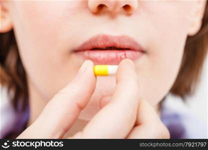 patient takes pill close up