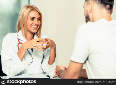 Patient visits doctor at the hospital. Concept of medical healthcare and doctor staff service.. Woman Doctor and Male Patient in Hospital Office