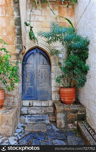Patio decorated with plants in a Greek house on the island of Rhodes. Vintage style