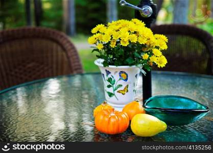 Patio table with flowers and gourds in fall