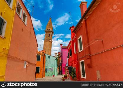 Patio with colorful houses and church on the famous island Burano, Venice, Italy