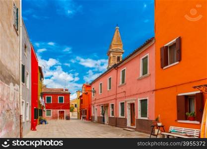 Patio with colorful houses and church on the famous island Burano, Venice, Italy