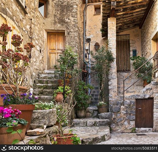 Patio with flowers in the old village Gourdon, France