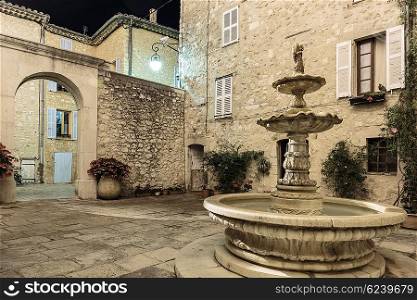 Patio with fountain in the old village Tourrettes-sur-Loup at night, France.