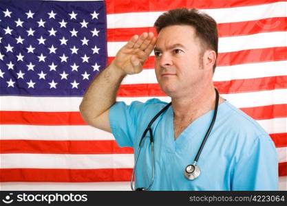Patriotic American doctor giving a salute to the flag. Photographed in front of flag, not a composite image.