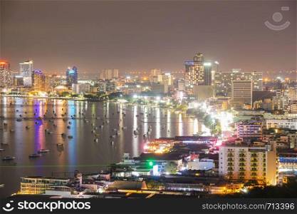 Pattaya city in evening. Skyscraper and building pattaya city. boats and ships in sea.