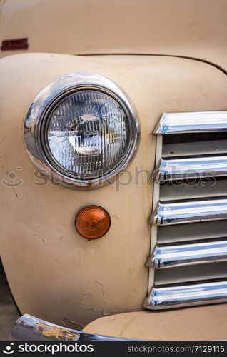 PATTAYA, JANUARY 9 : Color detail on the headlight of a vintage car on sheep a farm on January 9, 2016 in Pattaya, Chonburi province.