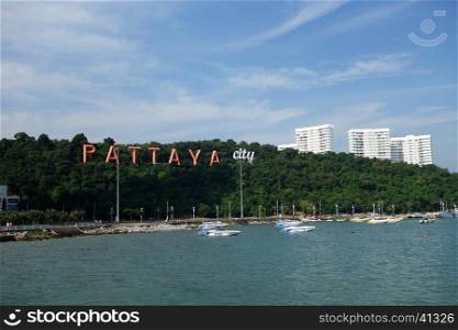 PATTAYA, THAILAND - 22 NOV, 2016: Pattaya bay with commerical boats and the Pattaya City sign on the hill