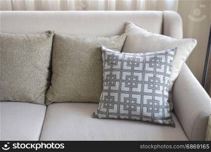 Pattern and texture pillows on beige sofa in the living room