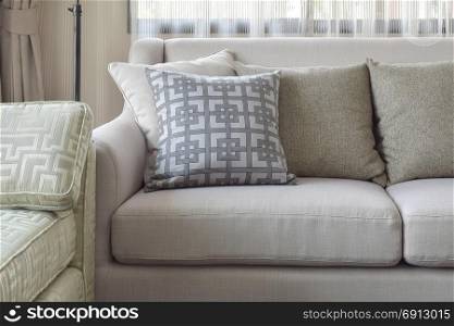 Pattern and texture pillows on beige sofa in the living room