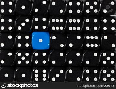 Pattern background of random ordered black dices with one blue cube. Background of random ordered black dices with one blue cube
