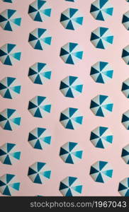 Pattern of blue umbrellas over a pastel pink background, minimalism, design and digital resource, background with copy space