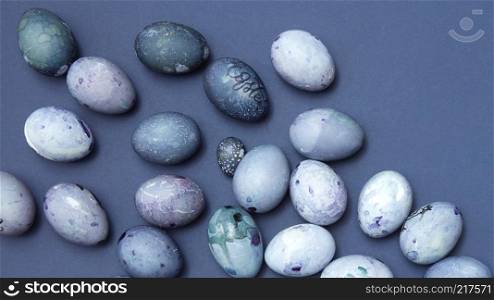 Pattern of easter eggs on blue background, flat lay. Pastel colored Easter eggs