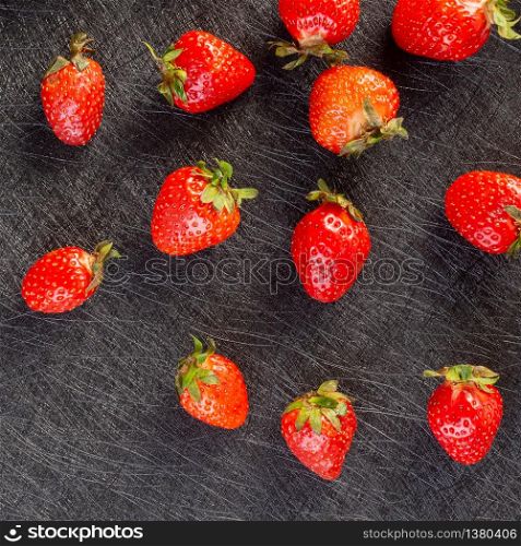 Pattern of fresh strawberries on a black background. Strawberry pattern on a black background