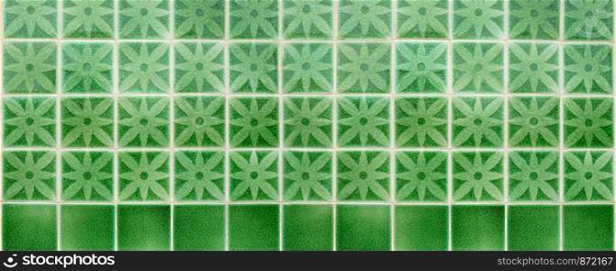 Pattern of green flower glazed tiles. Banner texture background.