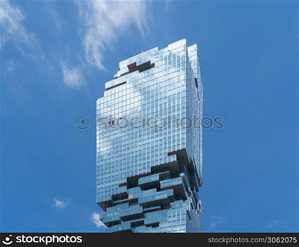 Pattern of office buildings windows. Glass architecture facade design with reflection in urban city, Downtown Bangkok. Urban city in financial district with blue sky. Mahanakhon.
