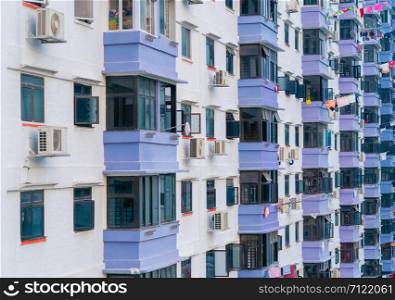 Pattern of old residential buildings, houses windows with clothes. Architecture facade design with reflection of sky in urban city, Singapore.