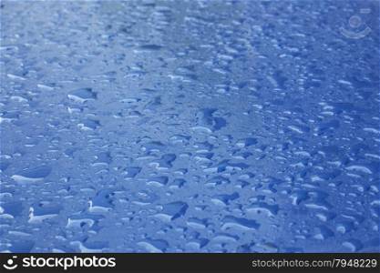 pattern of raindrops on shiny blue surface