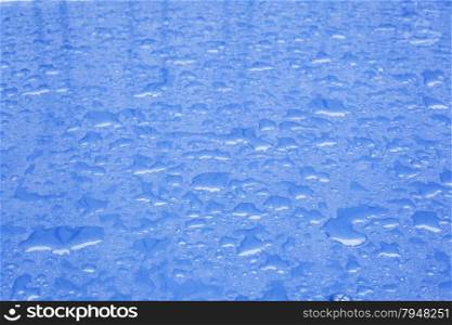 pattern of raindrops on shiny blue surface