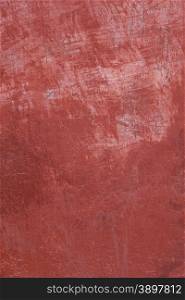 pattern on part of wall with plaster in different shades of red