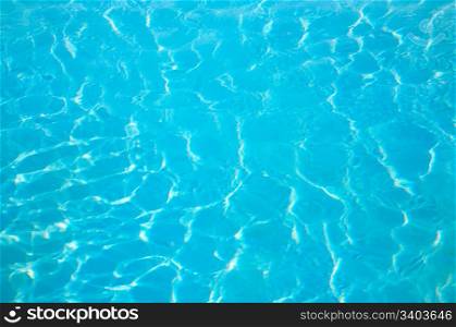 patterns of sunlight rippling o n a swimming pool water surface