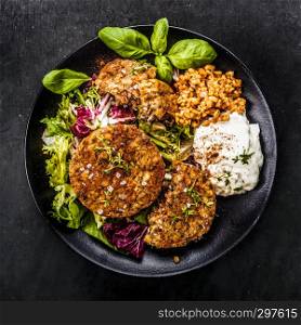 Patties on lettuce with bulgur and fresh herbs