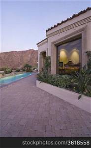 Paved poolside area and window exteriors of Palm Springs home