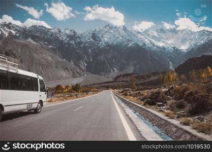 Paved road in Passu with a view of snow capped mountain range, Karakoram highway in Gojal Hunza. Gilgit Baltistan, Pakistan.