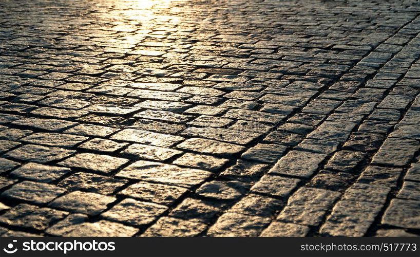 Paving stone close up and sunlight at dawn. Paving stone and sunlight