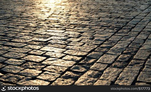 Paving stone close up and sunlight at dawn. Paving stone and sunlight