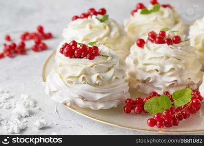 Pavlova cakes with cream and fresh summer berries. Close up of Pavlova dessert with forest fruit and mint. Food photography