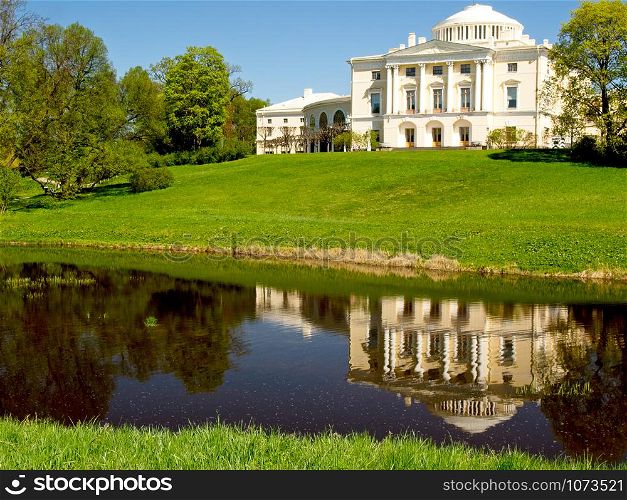 Pavlovsk, Russia, - May 04, 2019: Pavlovsk Palace reflecting in water in Pavlovsk, St Petersburg Russia