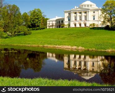 Pavlovsk, Russia, - May 04, 2019: Pavlovsk Palace reflecting in water in Pavlovsk, St Petersburg Russia