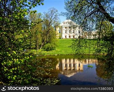 Pavlovsk, Russia, - May 04, 2019: View of the Palace of Emperor Paul in Pavlovsk through the foliage of trees in Pavlovsk, St Petersburg Russia