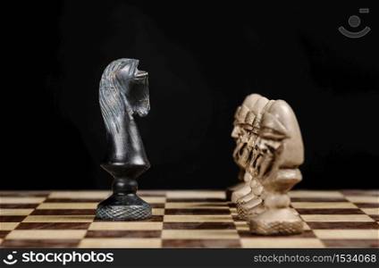 pawn chess pieces facing the knight on a chessboard