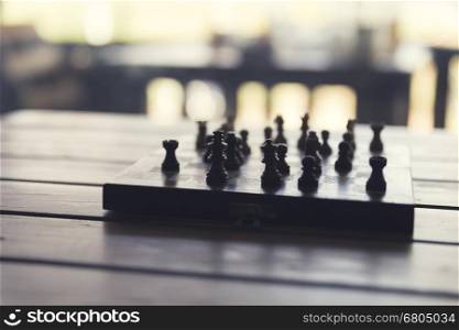 pawn of chess game on wooden table, vintage tone and selected focus