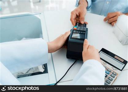 Payment by credit card with payment terminal in qualified drugstore or hospital. Modern payment of electric money. Closeup customer purchase medication in pharmacy with credit card on pos.. Closeup customer purchases qualified prescription medical drugs from pharmacist.