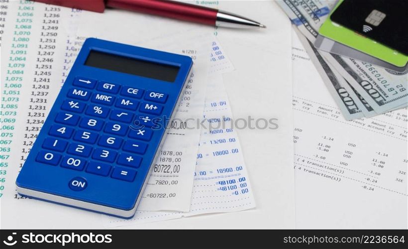 Payment card and calculator on top of supermarket receipt. Shopping and payment concept. store receipt and calculator