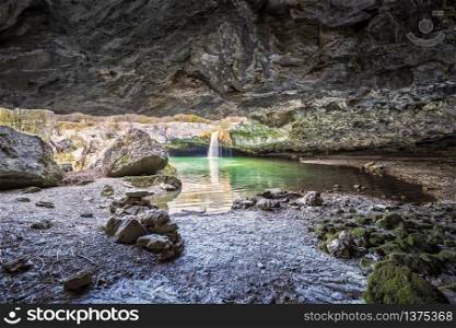 Pazincica river and waterfall Zarecki krov in springtime, view from the cave, Istria, Croatia