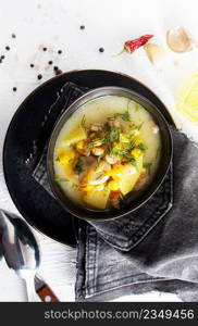 Pea soup with bacon and parsley in a bowl on a white background. Selective focus