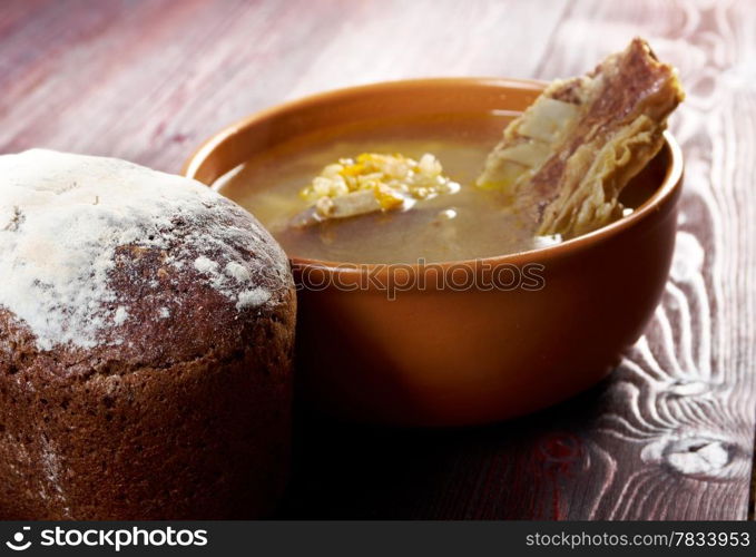 Pea soup with beef ribs and farmhouse bread,edible greens .farmhouse kitchen