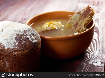 Pea soup with beef ribs and farmhouse bread,edible greens .farmhouse kitchen